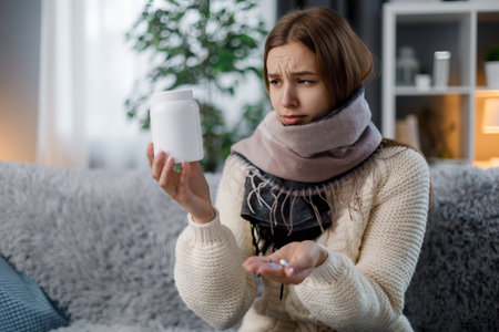 Sick woman taking pillsの写真素材