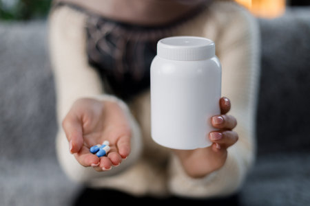Woman holding can and pillsの写真素材