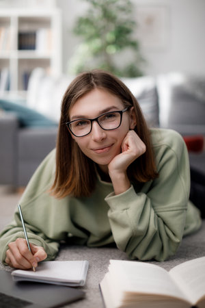 Woman with laptop and books studying