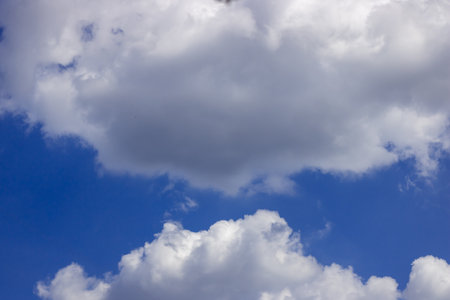 Beautiful blue sky and fluffy white clouds natural background.の写真素材