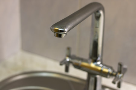 Mixer tap with flowing water. Closed tap in the kitchen.の写真素材