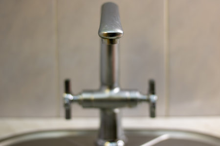 Mixer tap with flowing water. Closed tap in the kitchen.