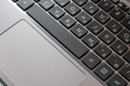 Laptop keyboard black on gray background. Close-up of laptop keyboard.