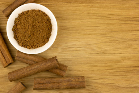How to identify spices cinnamon or cassia. Whole sticks spices on wooden textured background. Harm...