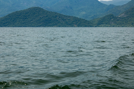 Croup of mountains around beautiful lake. Landscape on the natural park highlands. Panoramic view on the lakeshore.の写真素材