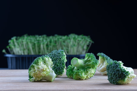 Bunch organic ripe broccoli fresh vegetable on wooden background. Micro greens plant cabbage...