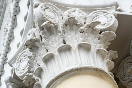 Architectural columns with figures and white stucco wealth. Solemn entrance to city park is made in style of stalin's empire. Propylaea richly decorated with symbols of the soviet era.の写真素材