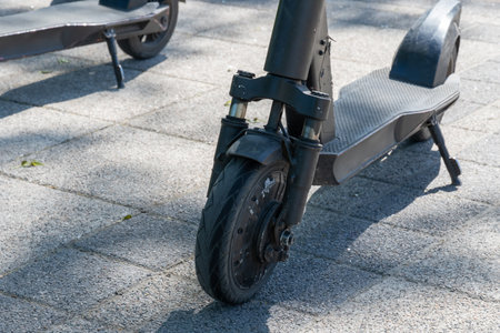 Details mechanism of used electric scooter close up. Wheel, shock absorber public mobile transport....