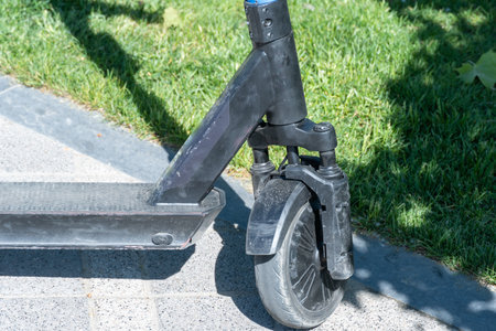 Details mechanism of used electric scooter close up. Wheel, shock absorber public mobile transport....