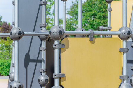 Outdoor sports ground in the city park. Street exercise equipment with horizontal bars, columns and...