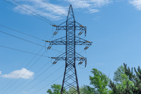 Electricity transmission towers and power lines in forest. High voltage pole on road. Energy concept...