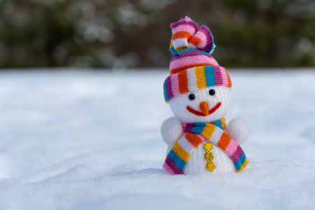 Snowman in christmas clothes stands on white snow in winter forest. Knitted bauble. Christmas and new year holidays decoration. Template for design christmas bauble. Symbol xmasの写真素材