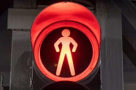 Red light of vintage traffic light close-up. Metallic old-fashioned stoplight. Safety equipment is...
