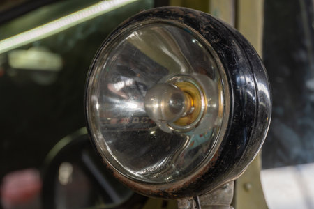 Headlight of vintage car close-up. headlamp of old-fashioned automobile. Searchlight as detail of retro vehicle. Optics in good condition. Machine elegance part.の写真素材
