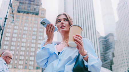 Portrait of attractive pretty Caucasian young woman sending voice messages using smartphone and...