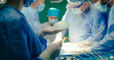 Multicultural team of professional plastic surgeons performs plastic surgery in modern private...