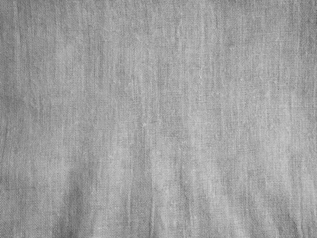 Gray cloth fabric texture background with burlap detail and some dark space.の写真素材