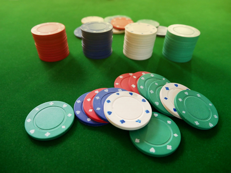 Group of coloful gamble chips on the green velvet carpet, cosino.の写真素材