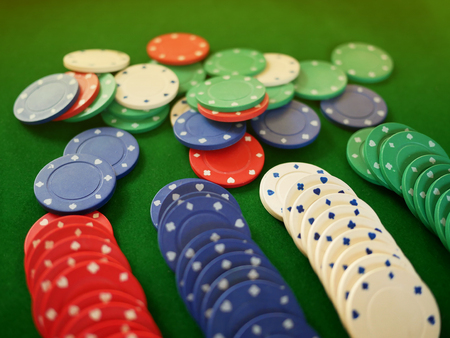 Group of coloful gamble chips on the green velvet carpet, cosino.の写真素材