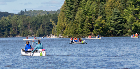 August 24, 2019 - Canoe Lake, Ontario, Canada: People paddling canoes on Canoe Lake in Algonquin Provincial Parkのeditorial素材