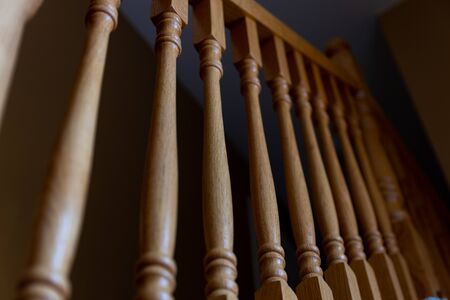 Selective focus on wooden bars and handrail or staircase