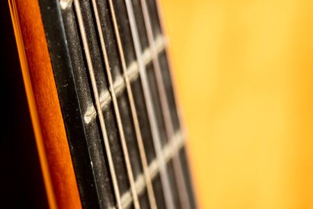 Selective focus on strings or acoustic guitar in morning sunlight
