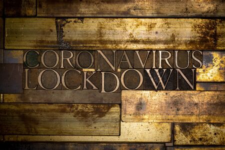 Photo of real authentic typeset letters forming Coronavirus Lockdown text on vintage textured grunge copper backgroundの写真素材