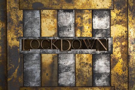 Photo of real authentic typeset letters forming Lockdown text on vintage textured grunge copper and black backgroundの写真素材