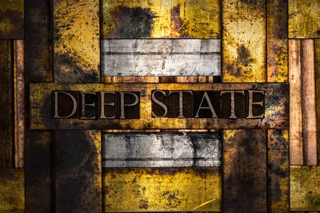 Deep State text formed with real authentic typeset letters on vintage textured silver grunge copper...