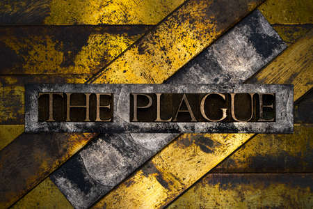The Plague text formed with real authentic typeset letters on vintage textured silver grunge copper...