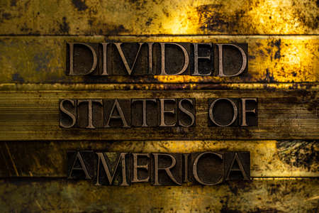 Divided States of America text formed with real authentic typeset letters on vintage textured silver grunge copper and gold backgroundの写真素材