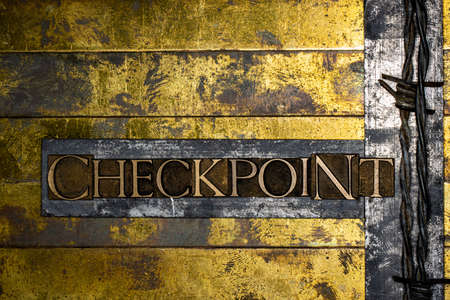 Checkpoint text message on textured grunge copper and vintage gold backgroundの写真素材