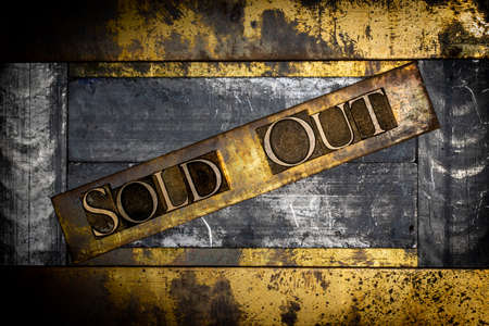 Sold Out text message on textured grunge copper and vintage gold backgroundの写真素材