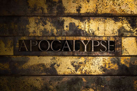 Apocalypse text formed with real authentic typeset letters on vintage textured silver grunge copper and gold backgroundの写真素材