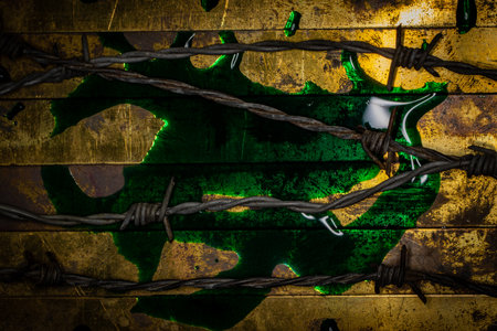 Green toxic fluid on textured grunge copper  with barbed wireの写真素材