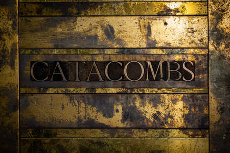Catacombs text on vintage textured bronze grunge copper and gold backgroundの写真素材