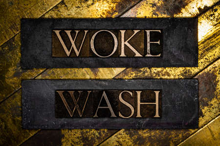 Woke Wash text message on textured lead grunge copper and vintage gold backgroundの写真素材
