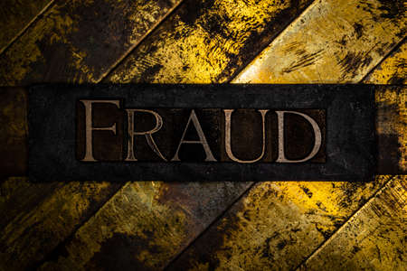 Fraud text on vintage textured grunge copper and gold backgroundの写真素材