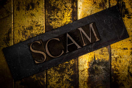 Scam text message on textured grunge copper and vintage shiny gold background