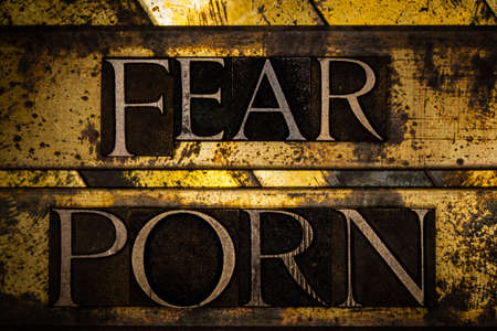 Fear Porn text formed with real authentic typeset letters on vintage textured silver grunge copper and gold backgroundの写真素材