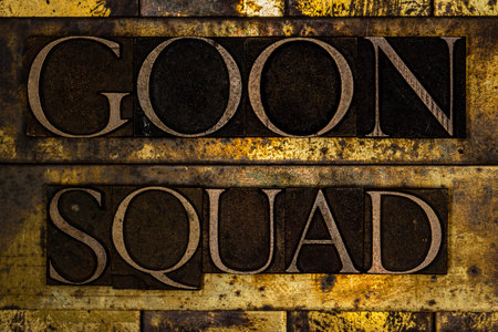 Goon Squad text on textured grunge copper and vintage gold backgroundの写真素材