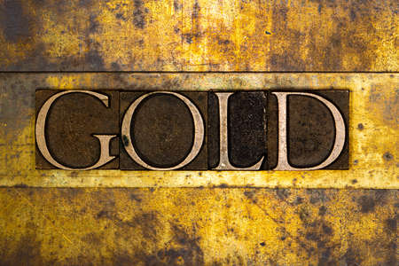 Gold text on textured grunge copper and vintage gold backgroundの写真素材
