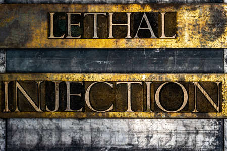 Lethal Injection text on textured grunge copper and vintage gold backgroundの写真素材
