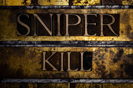 Sniper Kill text on textured grunge copper and vintage gold backgroundの写真素材