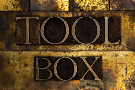 Toolbox text message on textured grunge copper and vintage gold backgroundの写真素材