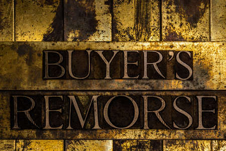 Buyer's Remorse text message on textured grunge copper and vintage gold backgroundの写真素材