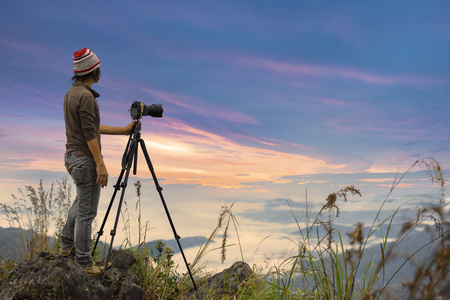 Photographer take a picture on the top of Mountainの写真素材