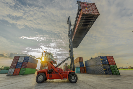 stacker forklift working on lifting unit of containers in yardの写真素材