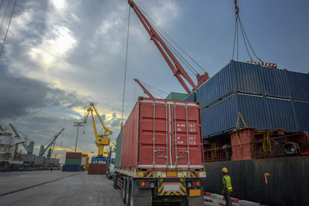 truck trailer or lorry delivery unit of containers from storage yard to the ship in the port...