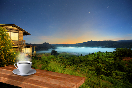 dawn scenery view from the coffee terrace with the stage of mist and fog flowing into the gorge canyon of the mountain, phu langka national park, Thailandのeditorial素材